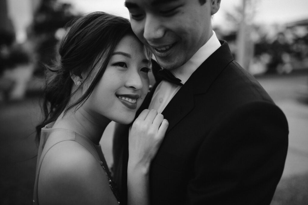 Women resting head on man wearing tuxado