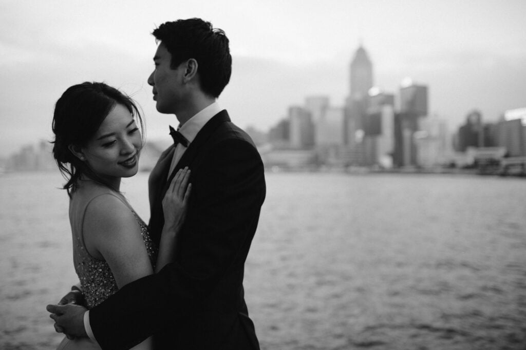 Couple embracing on portrait shoot at Victoria Harbour in Hong Kong