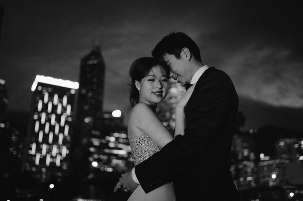 Portrait shoot of couple with backdrop of Hong Kong Skyline at night