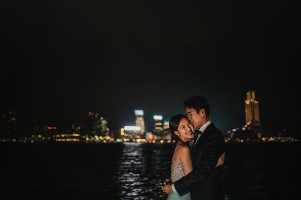 Portrait shoot of couple with backdrop of Hong Kong Skyline at night