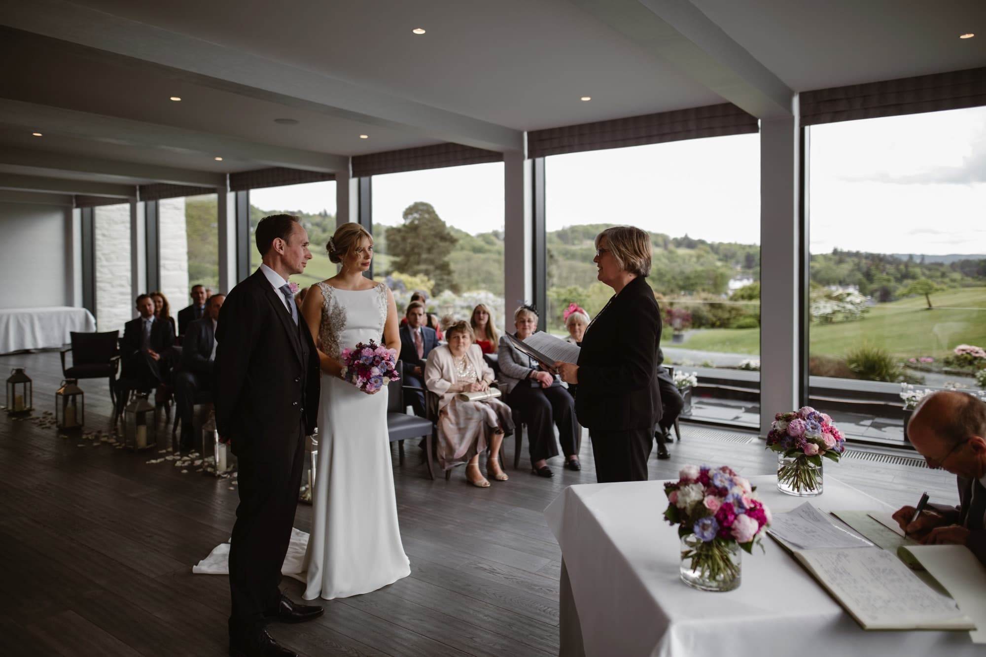 Internal shot of The Samling Hotel's large plate-glass windows during a wedding ceremony there showing the views