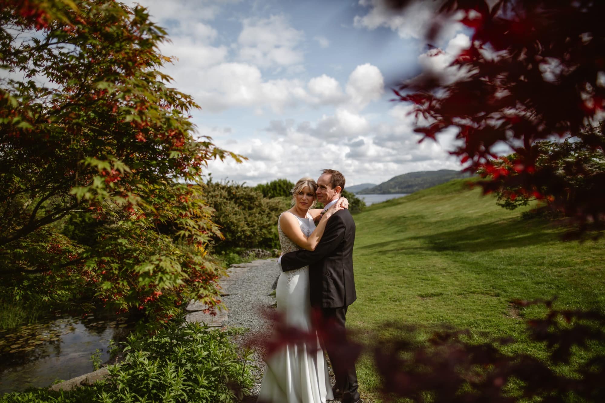 Bride & Groom embracing in the grounds of The Samling Hotel