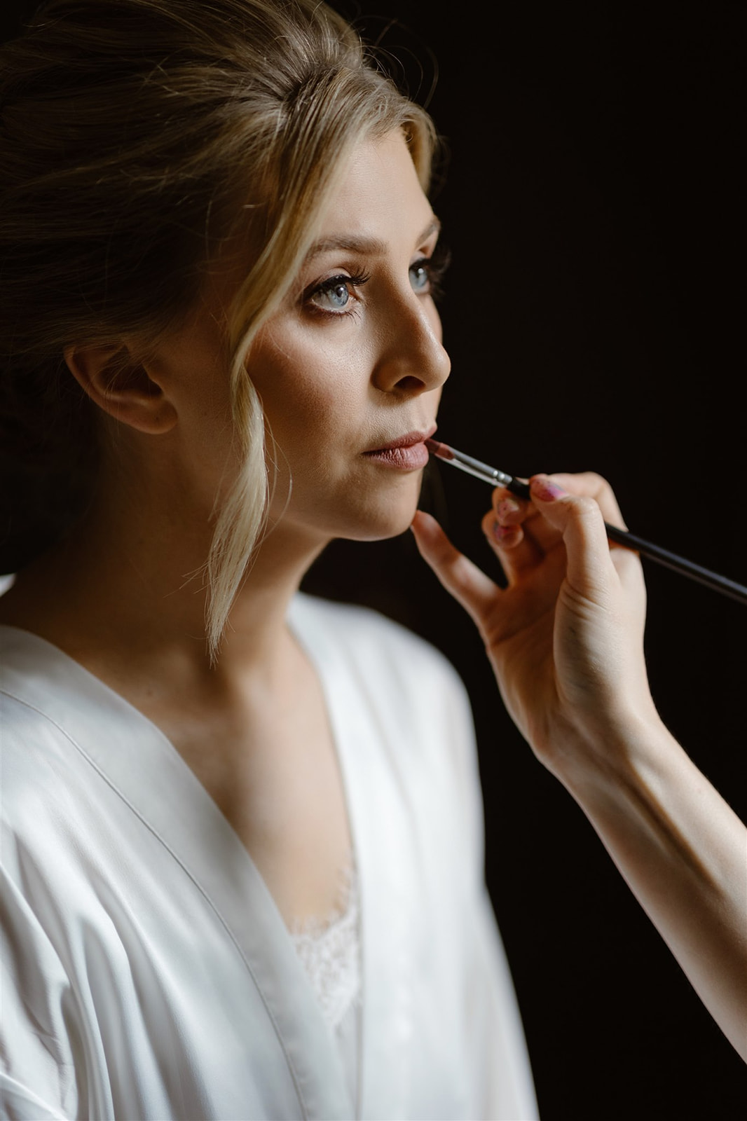 Bride having lip liner applied