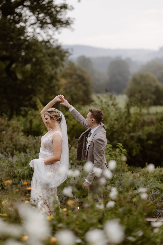 Bride and groom dancing in scenic garden