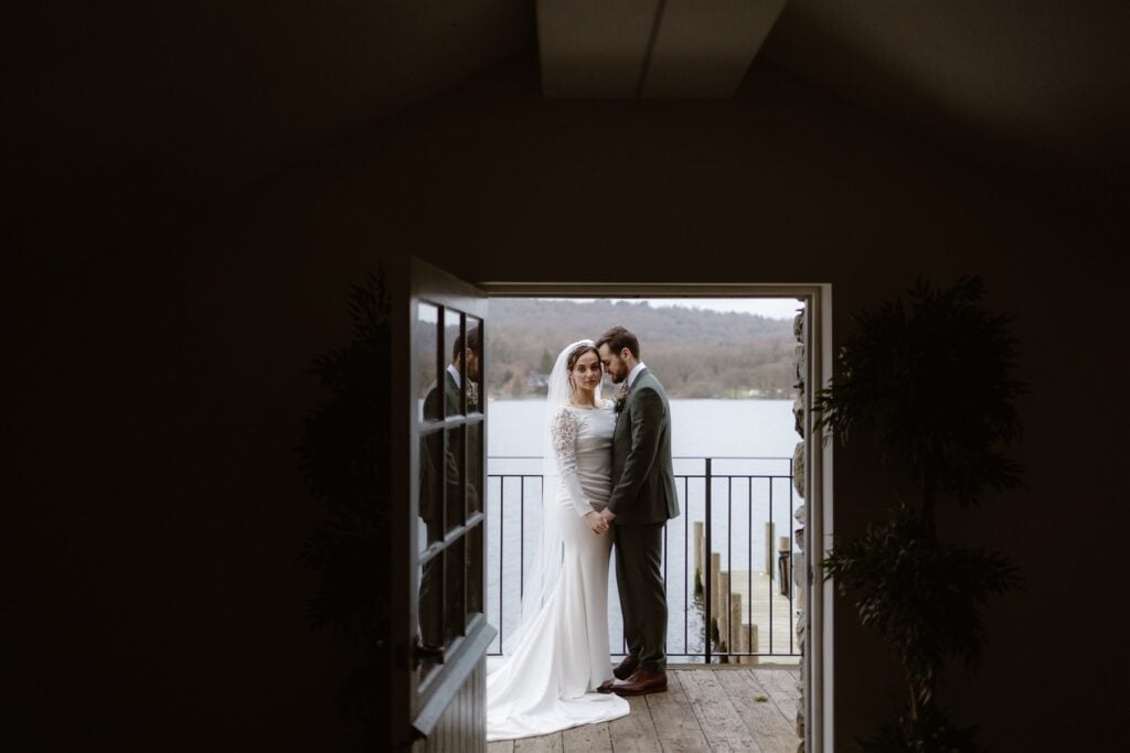 Bride and groom on balcony near lake