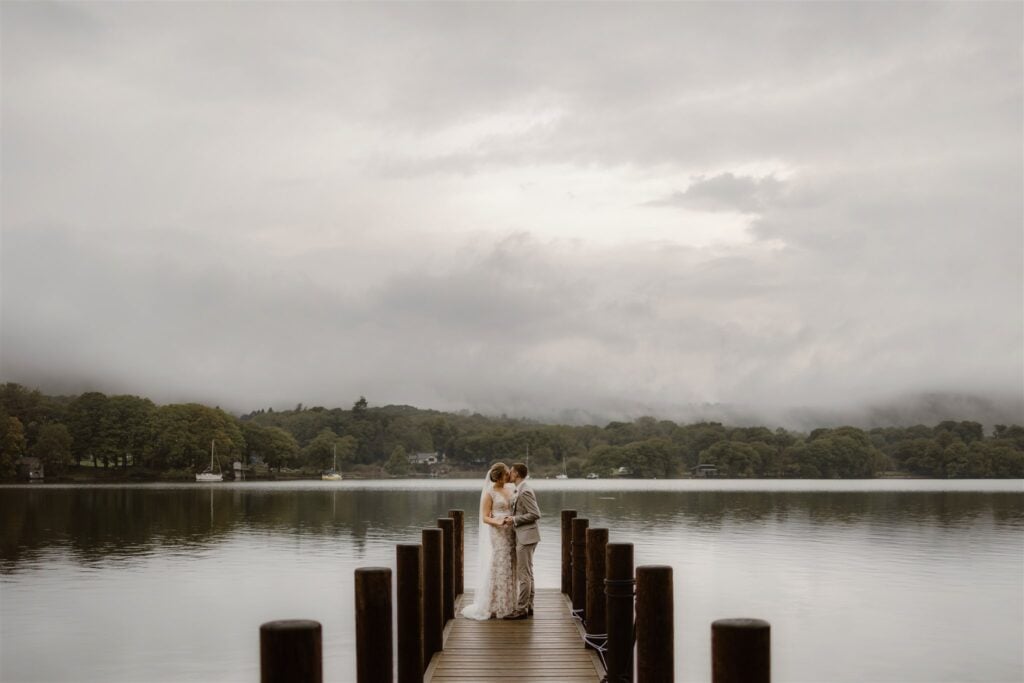 Bride and groom on a lakeside dock