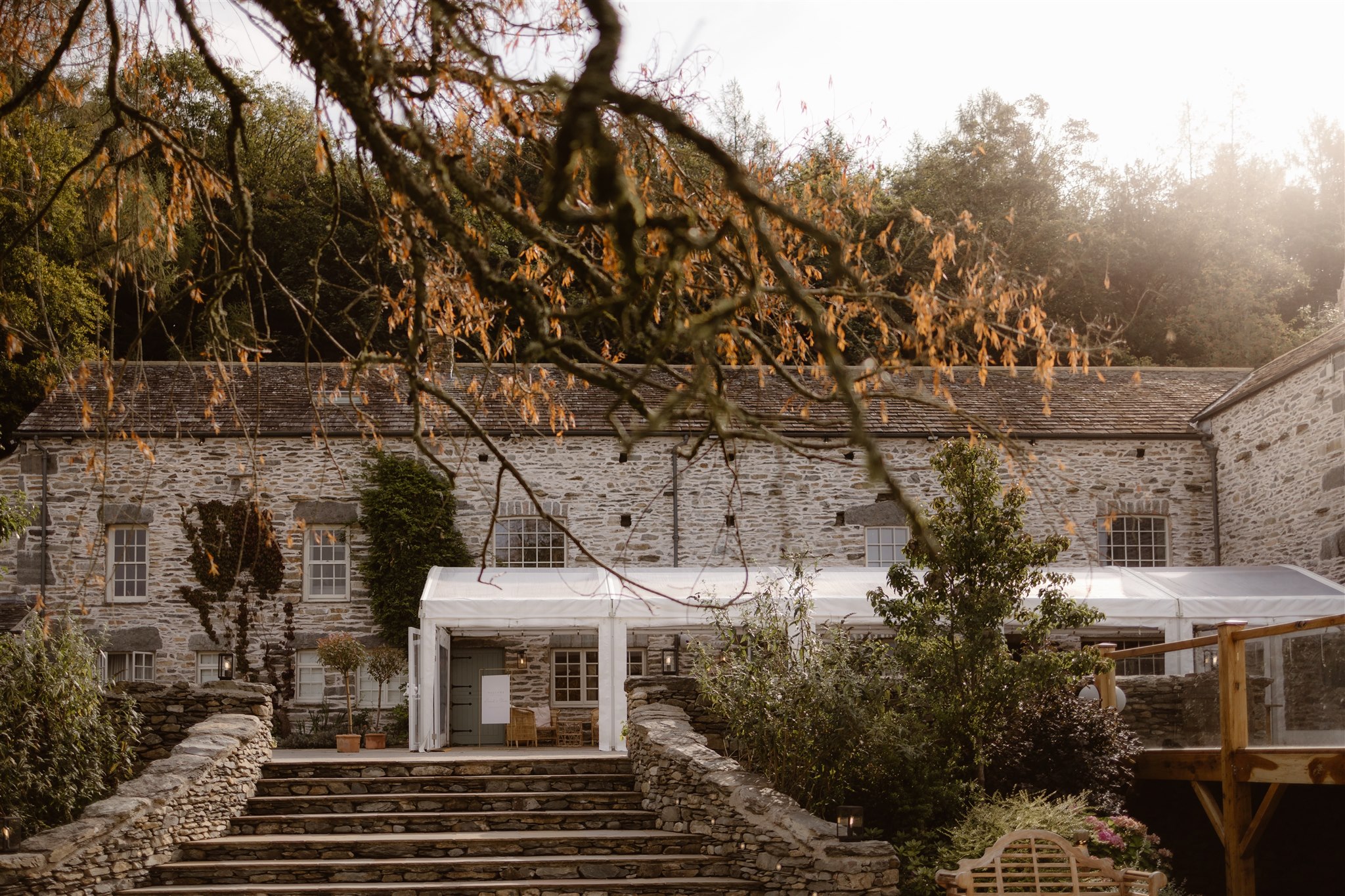Town Head Estate exterior in Autumn showing a stone building with a marquee extension.