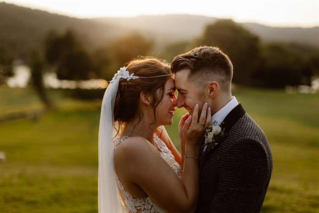 Bride and groom smiling at sunset in the grounds of the estate.