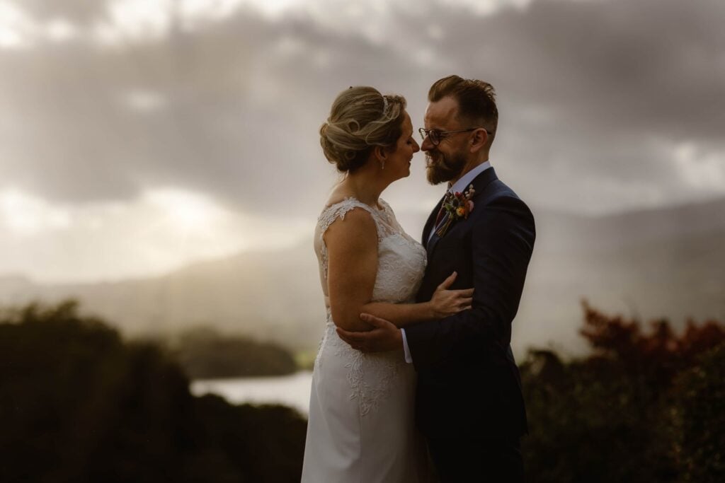 Couple embracing in front of mountains and lakes during their elopement