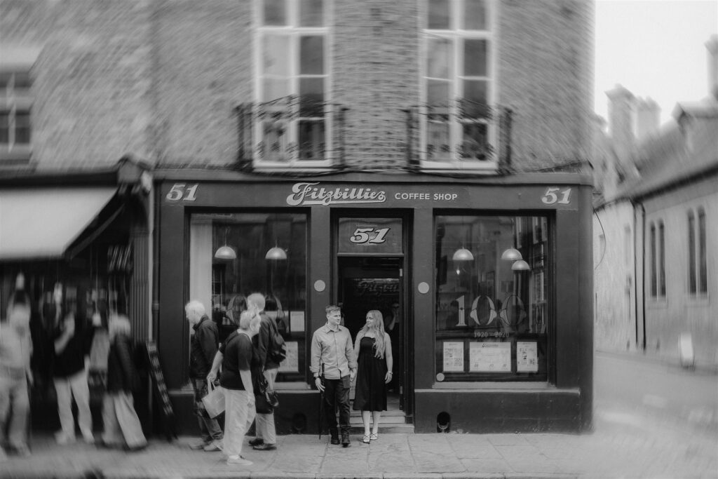 Couple stepping out of their favourite coffee shop during their pre-wedding couples shoot.