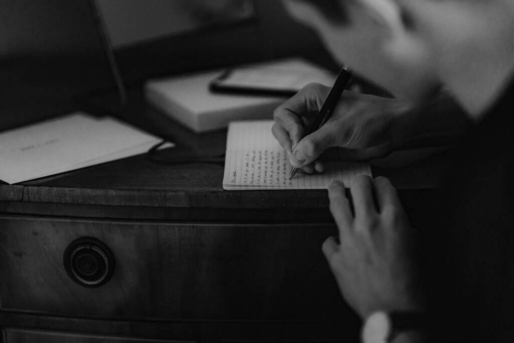 Groom writing elopement vows out