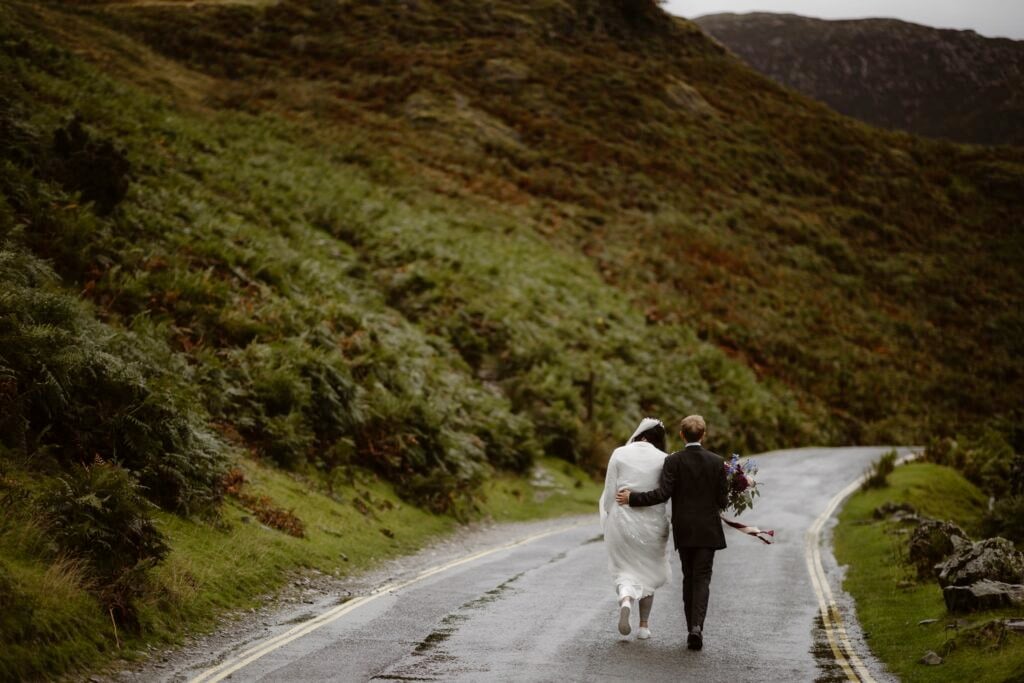 Couple walking away down an empty country road