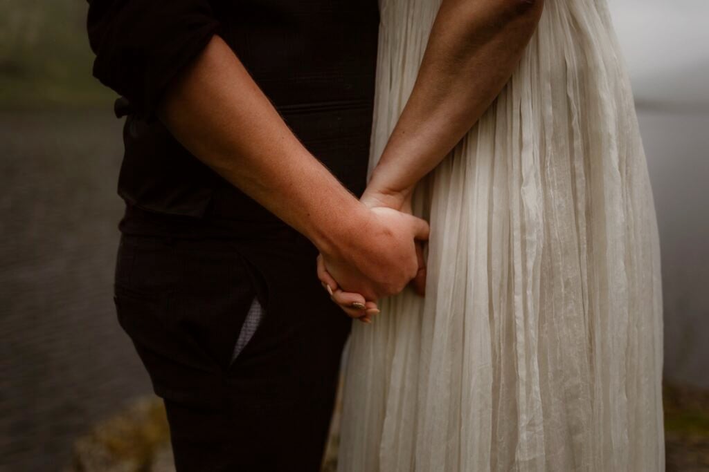Hands of couple during their elopement by Lake in Cumbria
