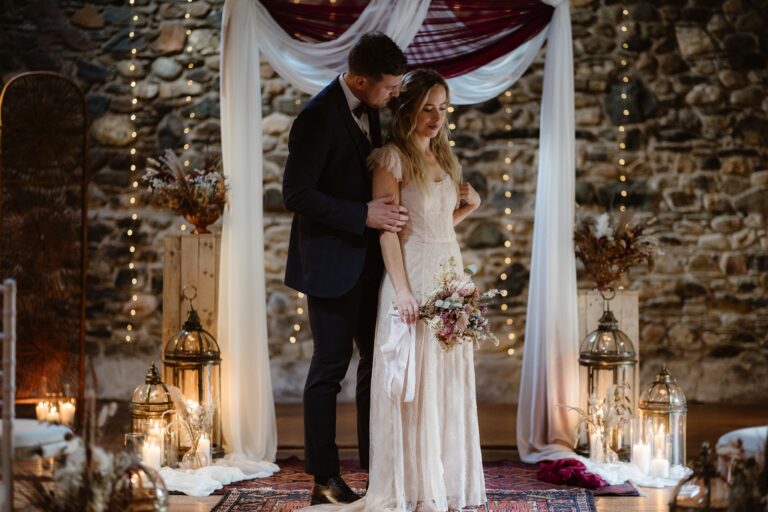 Groom embracing bride from behind inside Low Hall The Lakes