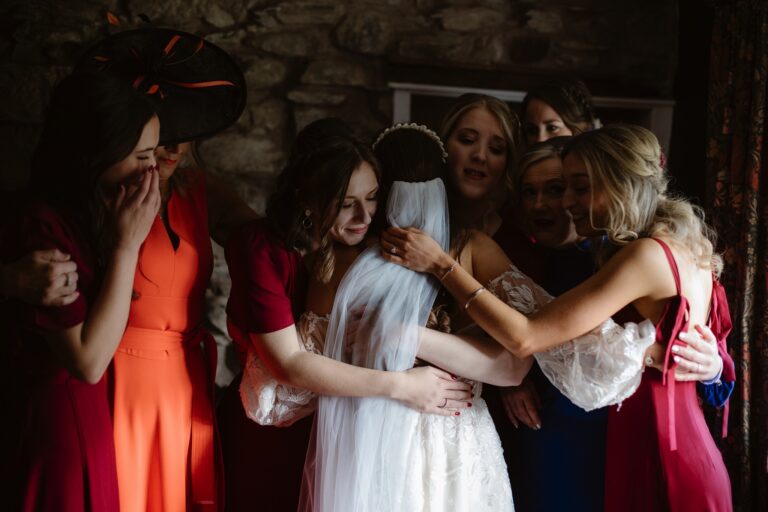 Bride embracing her friends on the morning of her wedding
