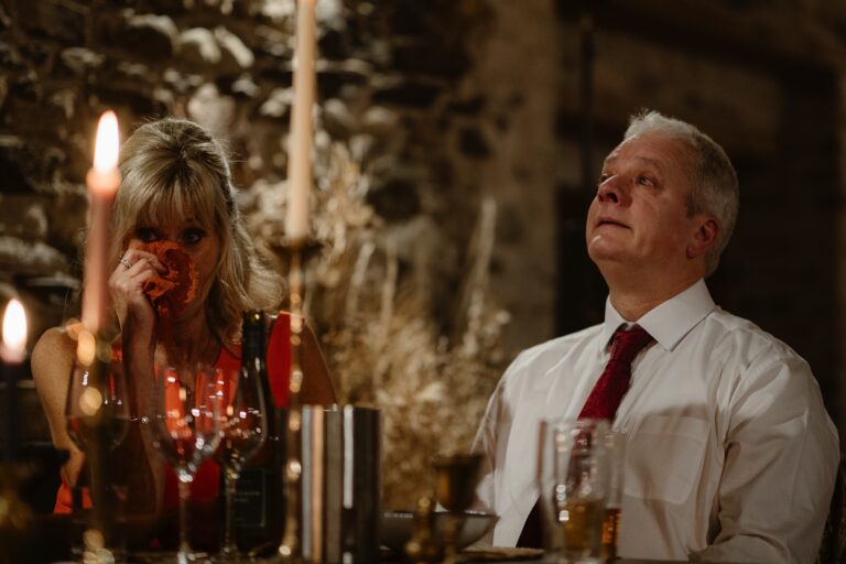 Man and woman crying during the wedding speeches