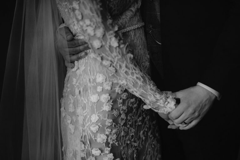 Detail shot of wedding dress and bride * Groom holding hands