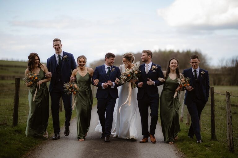 Bride & Groom walking with Bridesmaids and Groomsmen