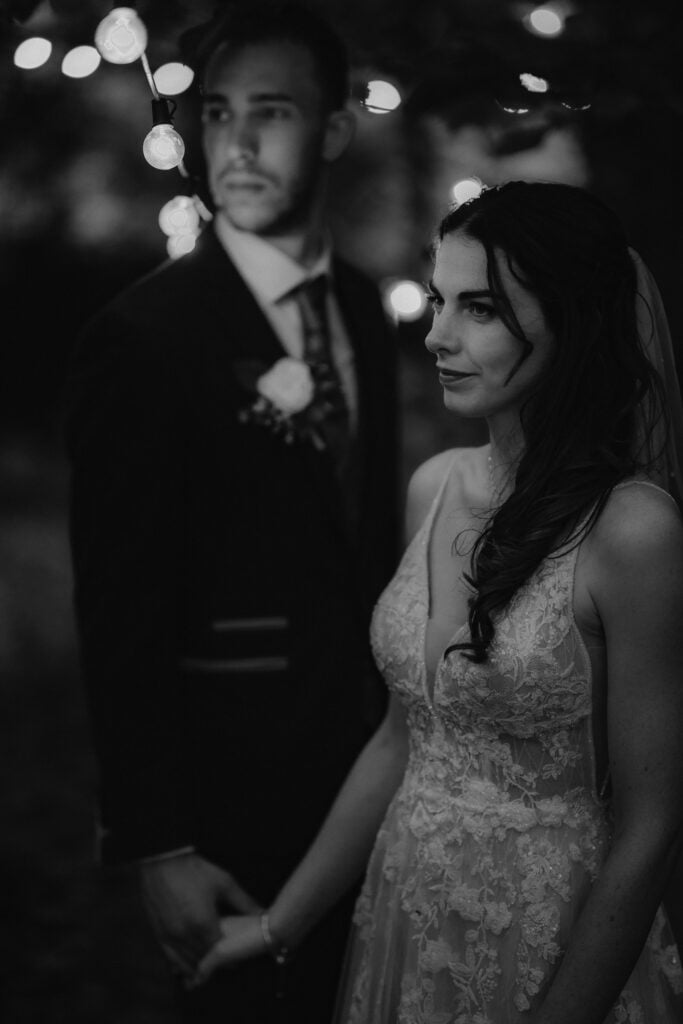 Portrait of bride and groom holding hands