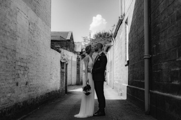 Bride & groom kissing in Alleyway