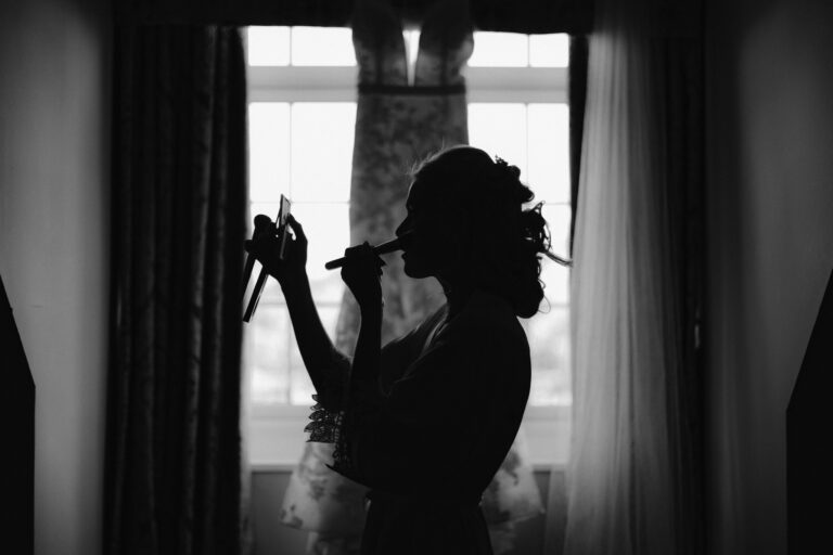 Bride applying her makeup