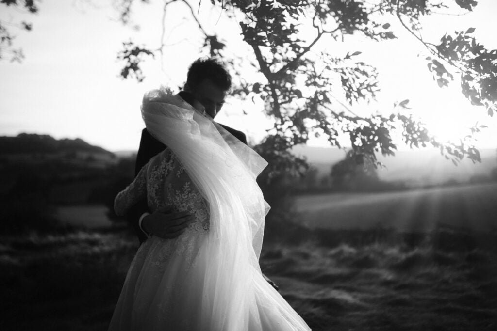 Bride & groom embracing in morning fog of their elopement