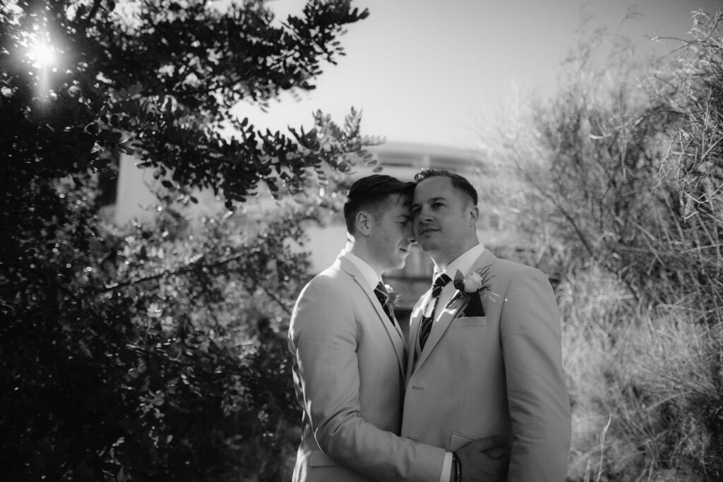LGBT male couple on the morning of their wedding embracing