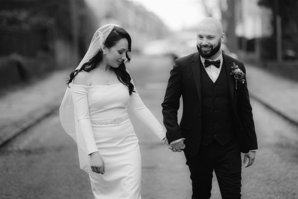 Bride & Groom walking through town after their elopement