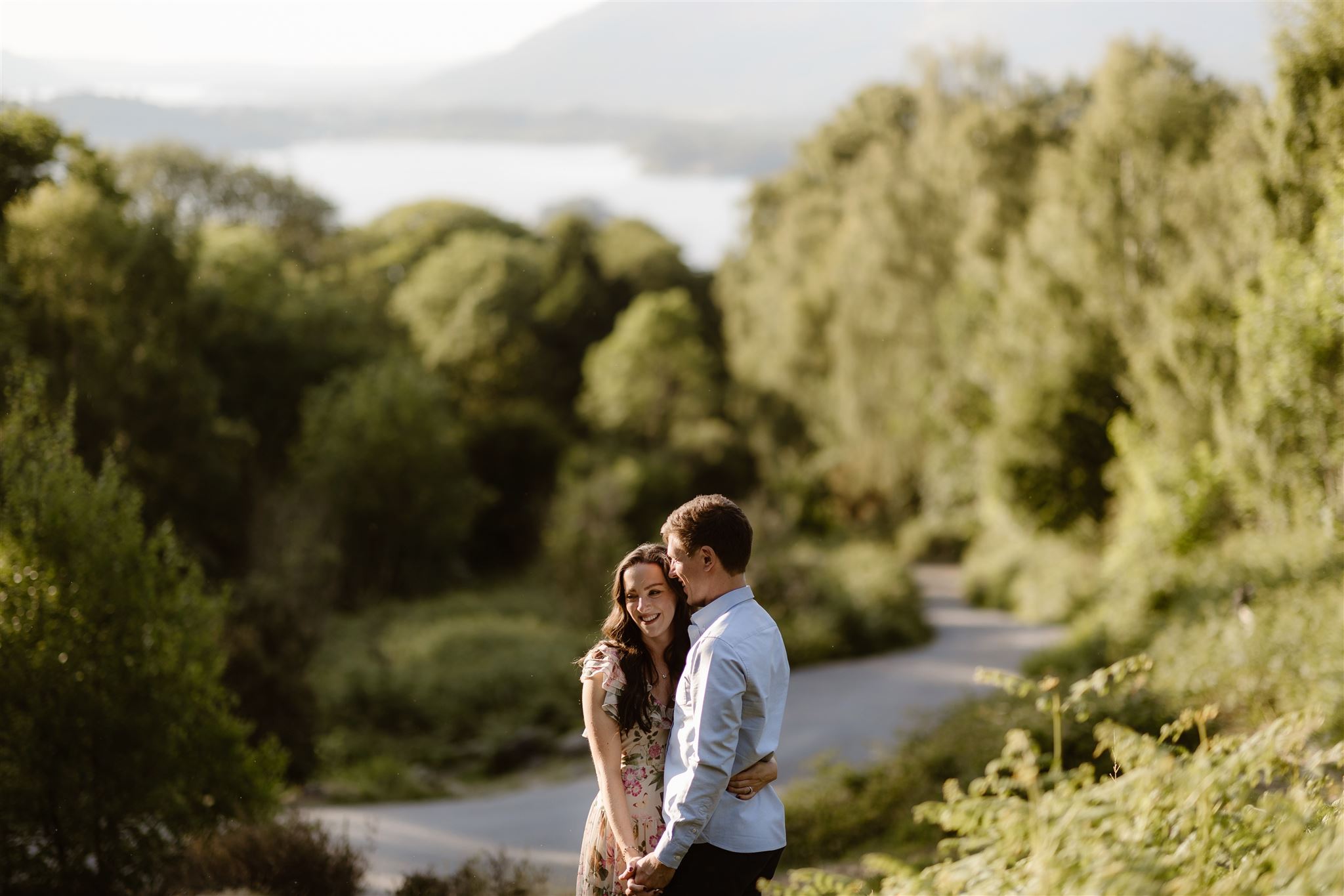 Couple stood hand-in-hand with backdrop of Derwentwater in the Lake District