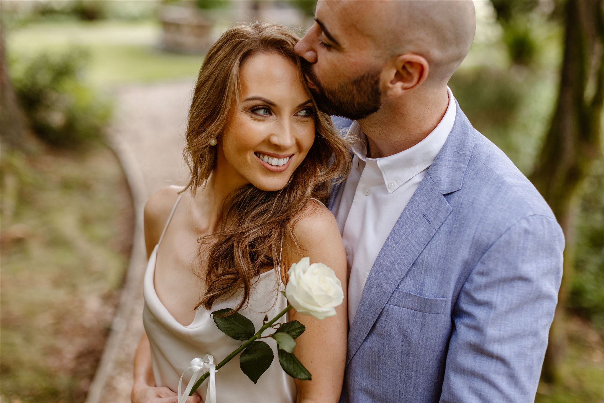 Couple embracing on their elopement in the grounds of Gilpin Lake House, Cumbria
