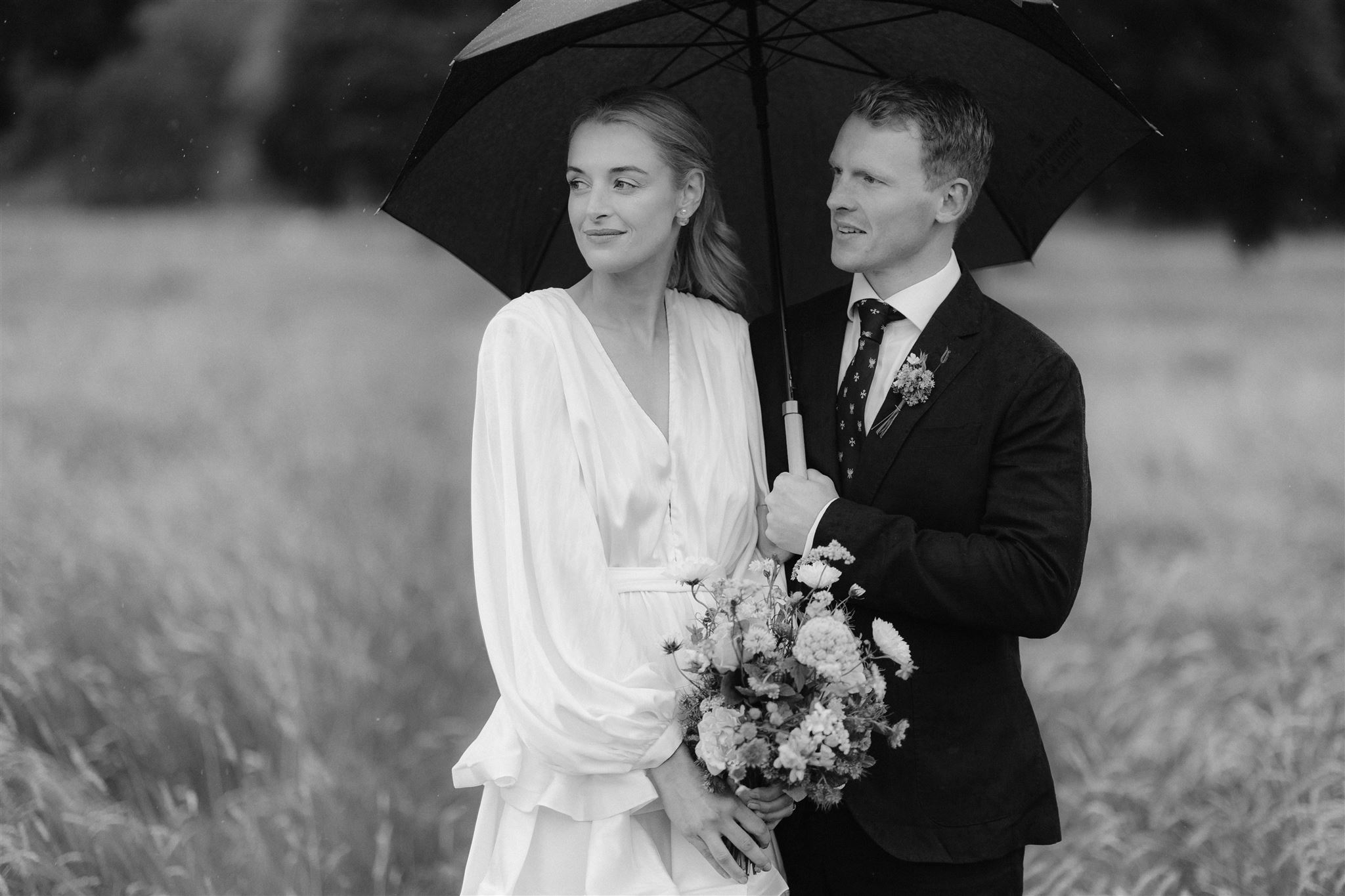 Bride & Groom under an umbrella during their elopement portrait shoot