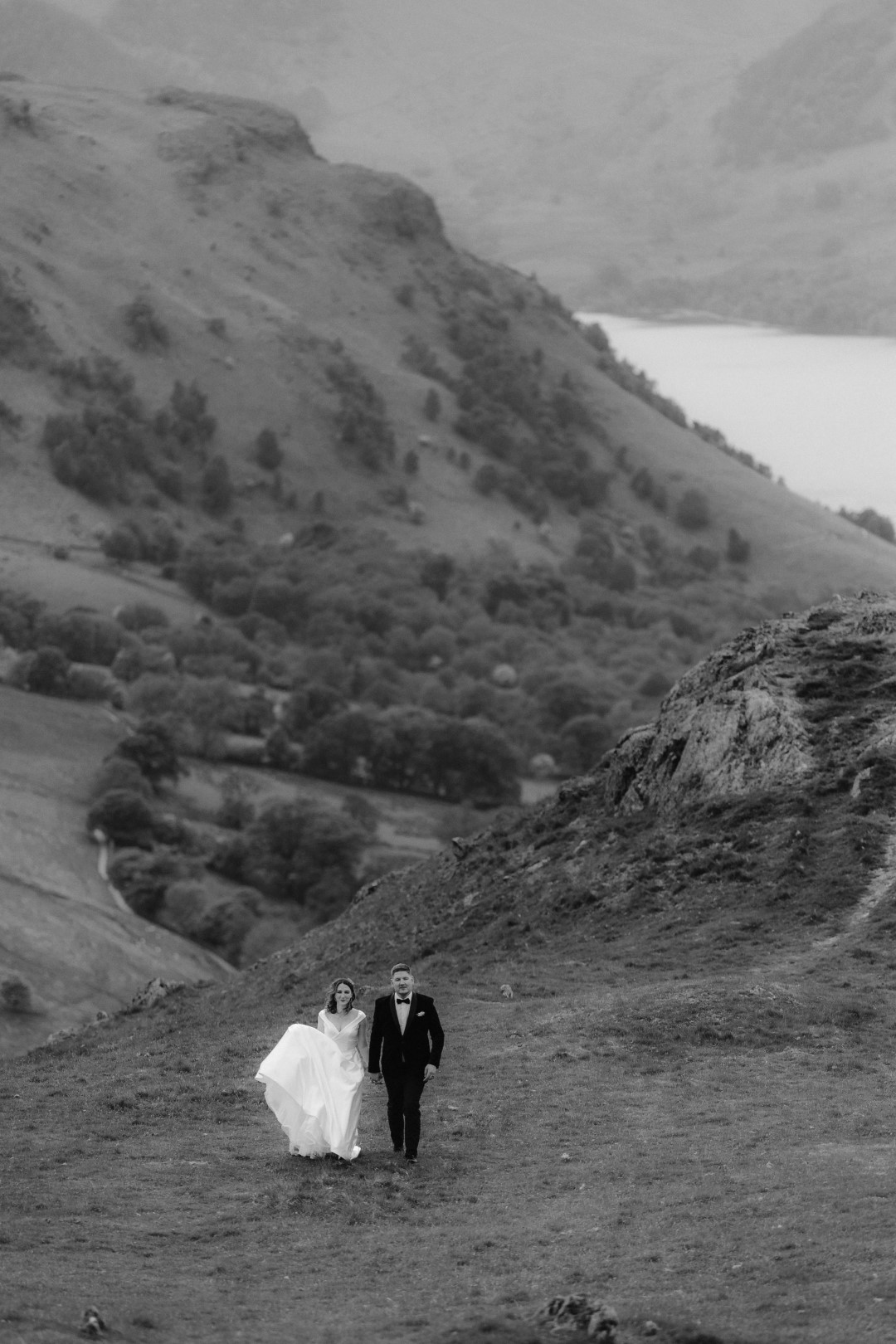 Bride & Groom walking on a mountainside in The Lake District