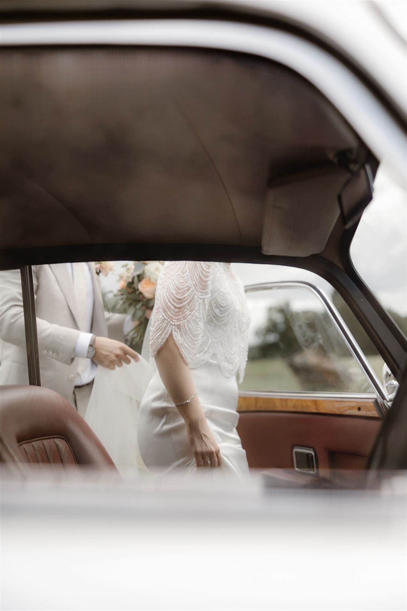 Image of bride getting into a car