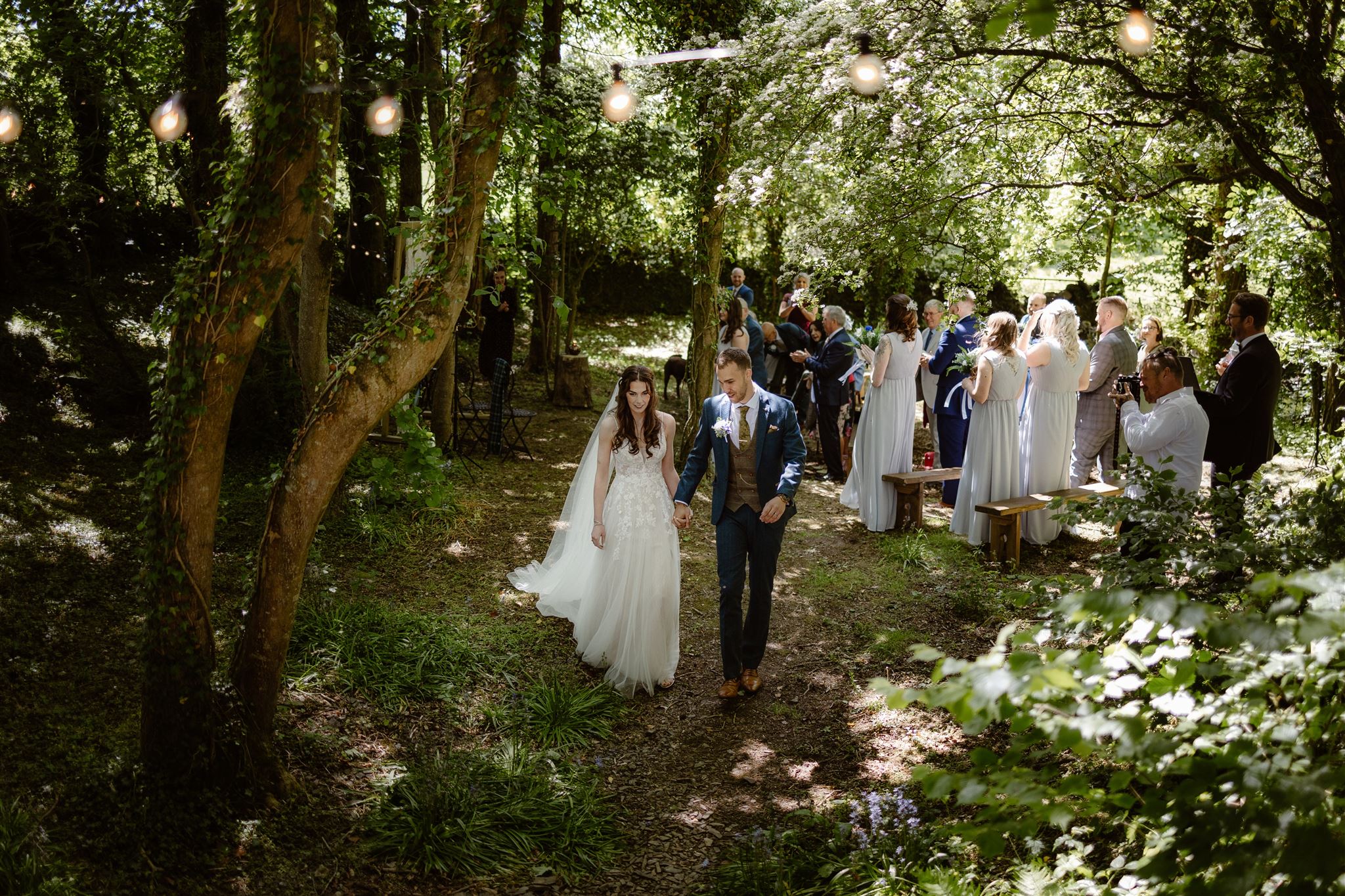 Outdoor wedding ceremony in a forest setting.