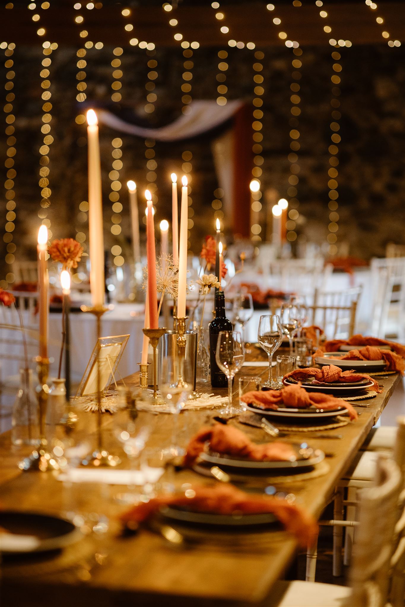 Elegant candlelit dinner table with festive decorations.